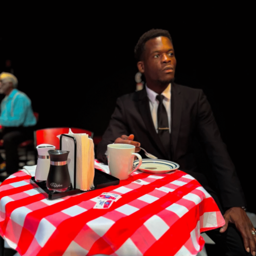 Andre sits a set table in character